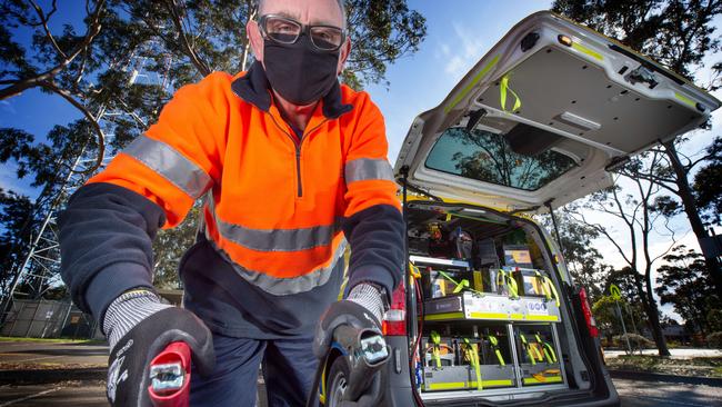 RACV's roadside assistant Patrick Griffin checks out a battery. Picture: Tony Gough