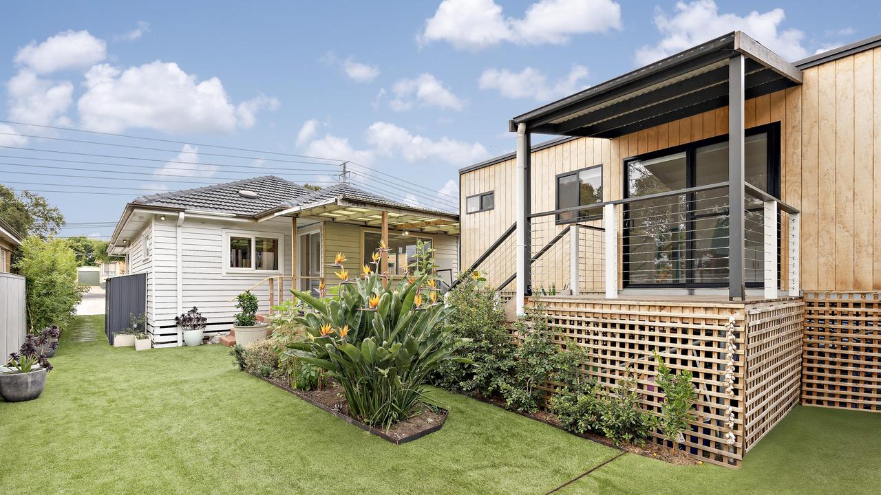 Generous backyard with storage sheds offers room to extend.