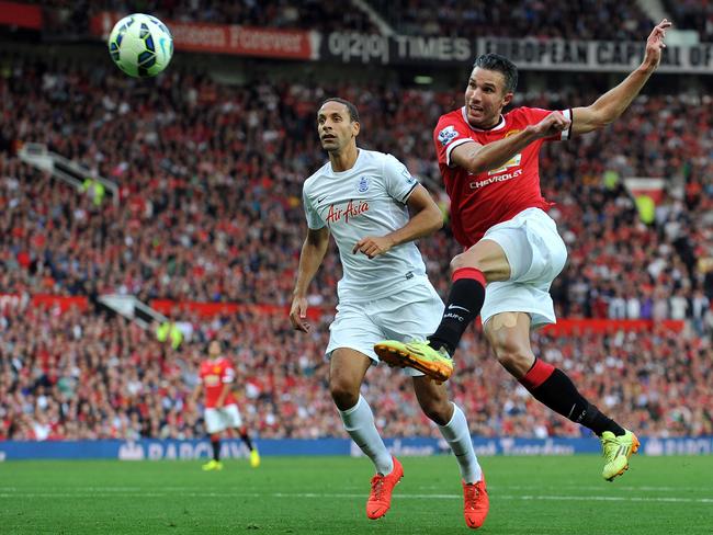 Robin van Persie (R) shoots past Queens Park Rangers' English defender Rio Ferdinand.