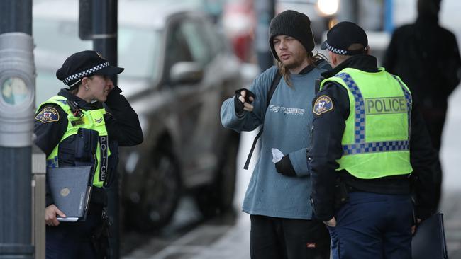 Tasmania Police officers interviewing people after the fatal stabbing of Voula Delios in North Hobart. Picture: LUKE BOWDEN