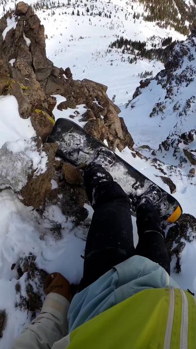 Terrifying moment snowboarder almost falls headfirst off cliff