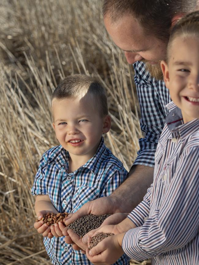 Kyle Pearse with Ted holding faba beans and Jack holding lentils. Picture: Zoe Phillips