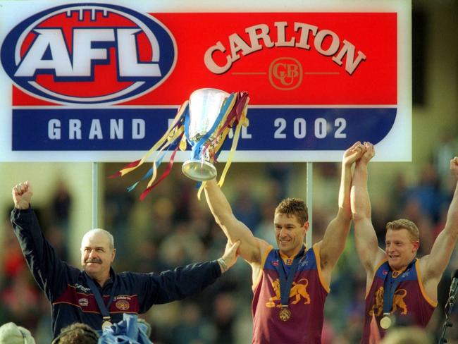 Leigh Matthews, Alastair Lynch and Michael Voss with the 2002 premiership cup.