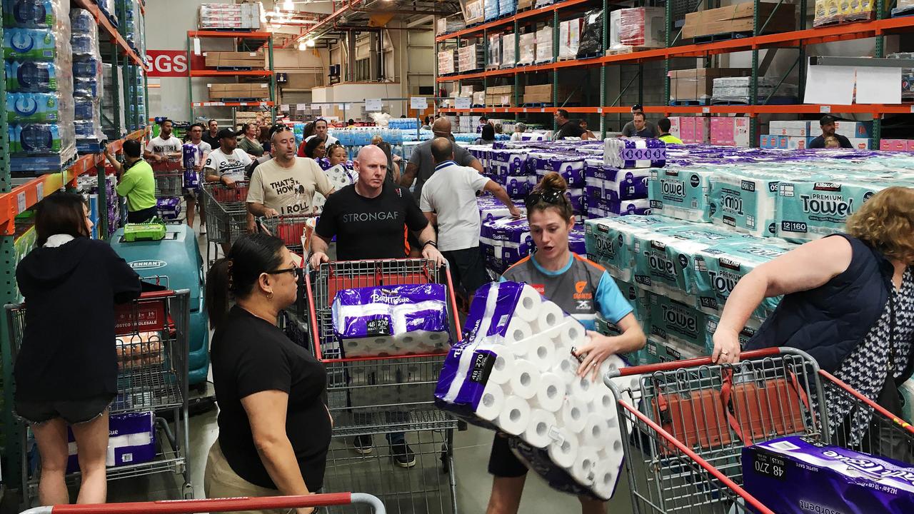 People buying toilet paper at Costco in Brisbane. Picture: AAP Image/Attila Csaszar