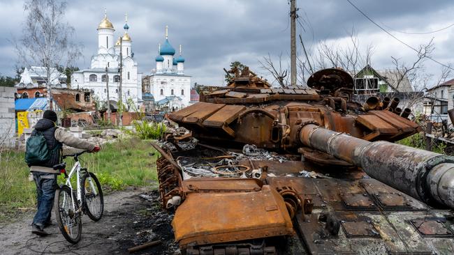 A cyclist passes a destroyed Russian tank in Sviatohirsk, Ukraine, in April. Picture: Getty Images