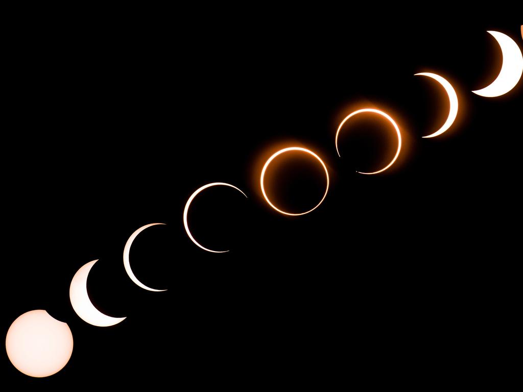 This composite image shows the moon as it moves in front of the sun in a rare "ring of fire" solar eclipse. Picture: AFP