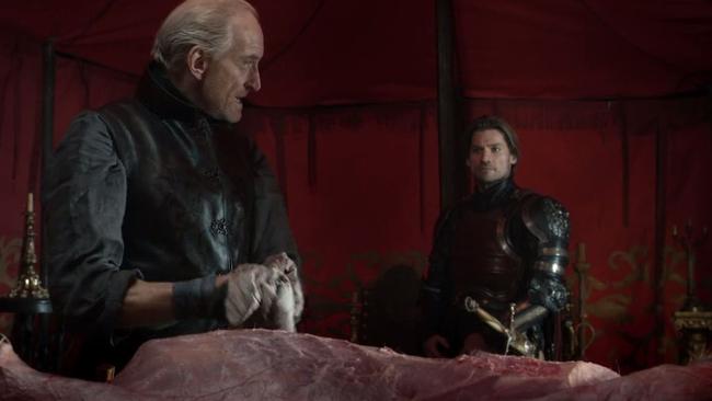 Tywin guts a stag while Jaime watches and listens.