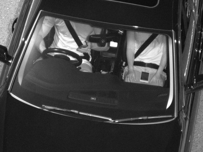 A driver and passenger snapped with mobile phones