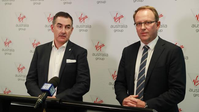 Pacific National’s Paul Scurrah when he was with Virgin Australia, and FTI’s senior managing director Vaughan Strawbridge. Picture: John Feder