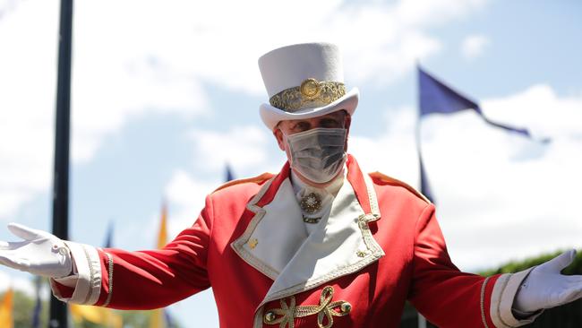 Punters were offered free masks by the racecourse as they began a Melbourne Cup day quite like no other. Picture: NCA NewsWire/Christian Gilles