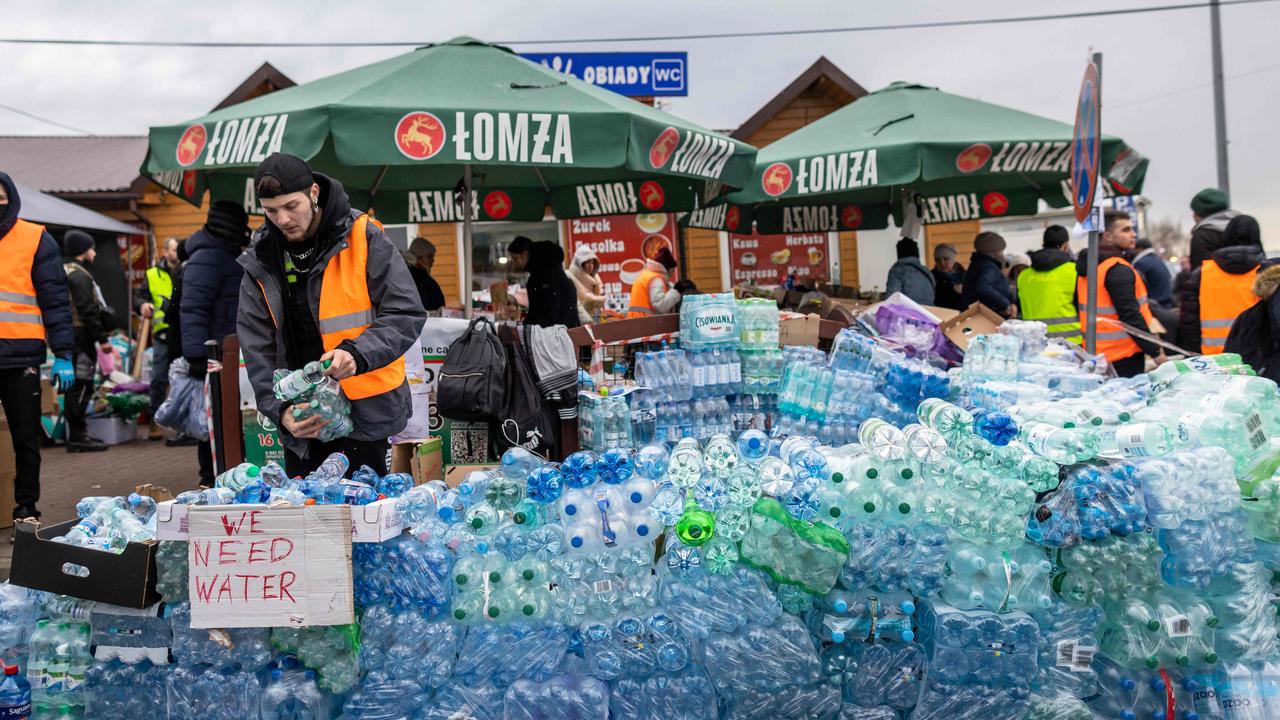 Activist prepare water at the Medyka pedestrian border crossing. Picture: Wojtek Radwanski/AFP