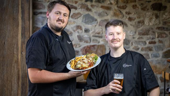 ADELAIDE, SOUTH AUSTRALIA - Advertiser Photos May 8, 2025 - The Macclesfield HotelÃs L to R Senior Chef Anselmo Massaro with fellow chef Chappo holding the Chicken PloughmanÃs Schnitzel, voted the best Schnitty in South Australia. Picture: Emma Brasier