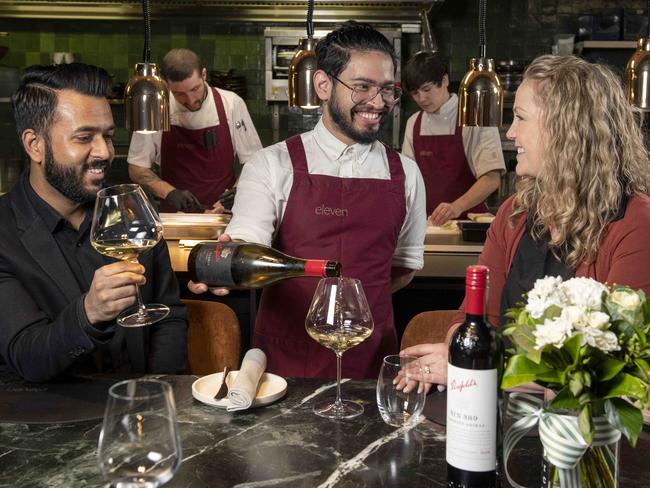 JUNE 10, 2022: Eleven is hosting a $300 a head dinner with Penfolds later this month. Staff member Clayton Johnson serving Divesh Lormorh and Nikki Potter. Picture: Naomi Jellicoe