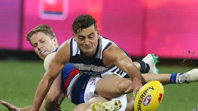 AFL Round 9. 18/05/2019. Geelong v Western Bulldogs at GMHBA Stadium.. Bulldog Lachie Hunter and Geelongs Luke Dahlhaus battle at ground level . Pic: Michael Klein.