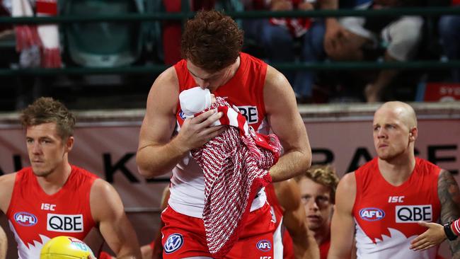 Gary Rohan walks out with baby Bella before his 100th game. Picture: Phil Hillyard