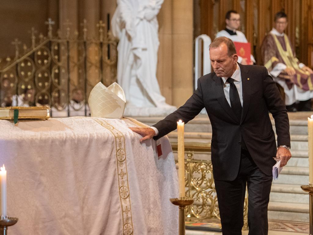 Former Prime Minister Tony Abbott touches the coffin of George Pell at he Solemn Pontifical Mass for Cardinal George Pell at St Mary's Cathedral, Sydney. Picture: please credit Giovanni Portelli, The Catholic Weekly