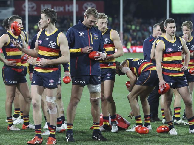 Daniel Talia signing a football after the Round 13 clash against Richmond at the Adelaide Oval. Picture Sarah Reed