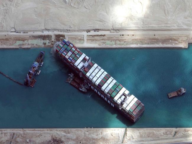 TOPSHOT - This satellite imagery released by Maxar Technologies shows the MV Ever Given container ship in the Suez Canal on the morning of March 28, 2021. - Hope rose on March 28, 2021 that salvage efforts would free a mammoth container ship blocking the Suez Canal for six days, crippling international trade and causing multi-million-dollar losses. The MarineTraffic and VesselFinder applications said two tugboats were heading to the vital waterway to bolster the salvage operation, while experts pinned hope on a high tide to help refloat the vessel. (Photo by - / Satellite image Â©2021 Maxar Technologies / AFP) / RESTRICTED TO EDITORIAL USE - MANDATORY CREDIT "AFP PHOTO / Satellite image Â©2021 Maxar Technologies" - NO MARKETING - NO ADVERTISING CAMPAIGNS - DISTRIBUTED AS A SERVICE TO CLIENTS