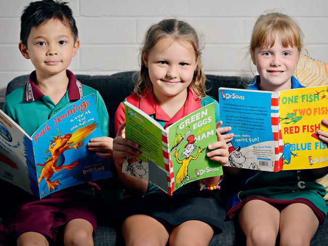 Tommy Edmund, 6, Skyler Gersch, 6, and Heidi Zoldak, 6, reading books for national children’s week.