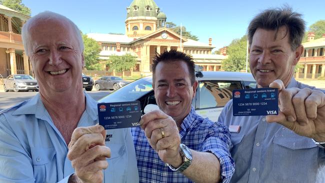 Regional Transport Minister Paul Toole (centre) promotes the regional seniors travel card with taxi driver Paul Shanahan and NSW TrainLink’s Phil Barker.