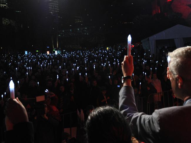 People attend a candlelight vigil to remember delegates who lost their lives on-board Malaysia Airlines flight MH17 en route to the AIDS Conference 2014, at Federation Square in Melbourne. Picture: AFP