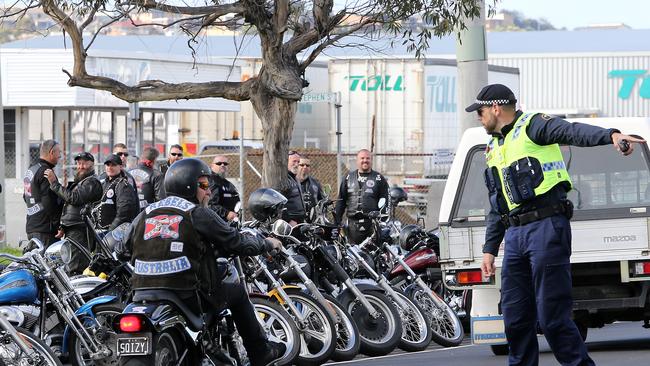 Police interact with bikies as they arrive at the Rebels Motorcycle Club at East Devonport.