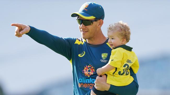 Australian captain Tim Paine checks out the MCG pitch with his son Charlie