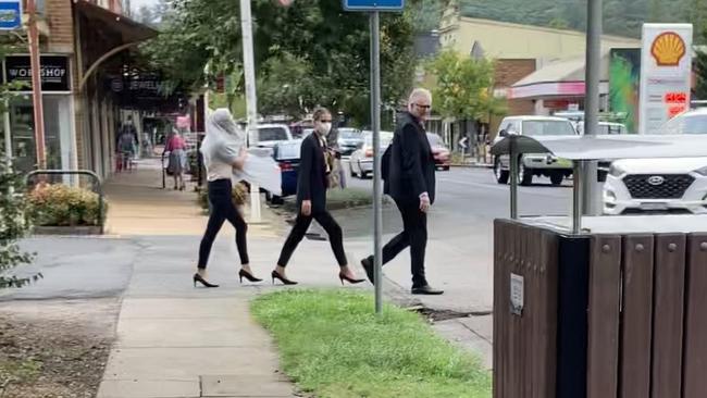 Sisters Lara Buttriss (a white blonde with scarf covering her hair) and Grace Buttriss (brunette) near Picton court with their lawyer. Picture: Adelaide Lang