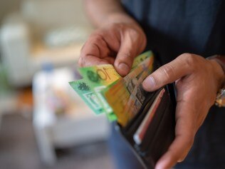 a male taking money out of a wallet, Australian cash generic spending