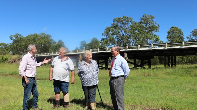 Chris Gulaptis is joined by Clarence Valley Mayor Jim Simmons (far right) and local residents Peter Williamson & ‘Teddy’ Bowles to welcome the announcement of repair of 31 timber bridges in the Clarence Valley, including two on the entrance to Coutts Crossing behind. Photo: Debbie Newton