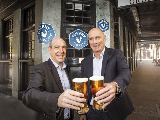 James Brindley MD Lion (R) and Frank Moreau GM of Beverages Merrivale, toasting to a free beer offer for vaccinated patrons. Picture: Chris Pavlich