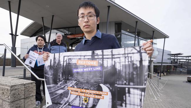 Roydon Ng with commuters campaigns for the restoration of the Inner West Line. Picture: Matthew Vasilescu