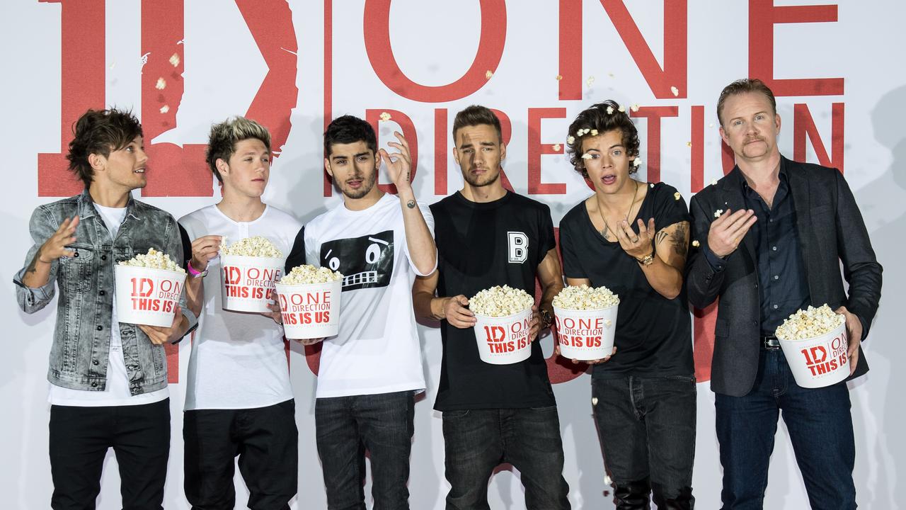 Louis Tomlinson, Niall Horan, Zayn Malik, Liam Pyne, Harry Styles and director Morgan Spurlock (far right) at a press call for concert film <i>One Direction This Is Us </i>in London in 2013. (Photo by Ian Gavan/Getty Images for Sony Pictures)