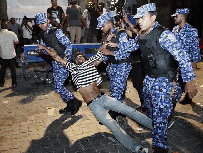 Maldivian police detain a protester demanding the release of political prisoners during a protest in Male, Maldives. Picture: AP