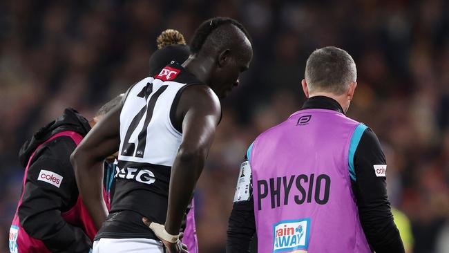 Aliir Aliir is escorted off the ground after his head knock in the Showdown. (Photo by Sarah Reed/AFL Photos via Getty Images)