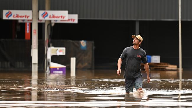 A man walks through floodwater on March 31, 2022 in Lismore. Picture: Dan Peled/Getty Images