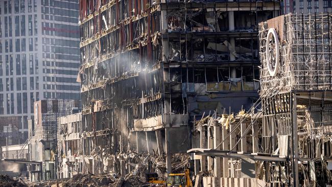 Ukrainian firefighters work amid the rubble of the Retroville shopping mall in Kyiv, a day after it was shelled by Russian forces on March 21. Picture: AFP