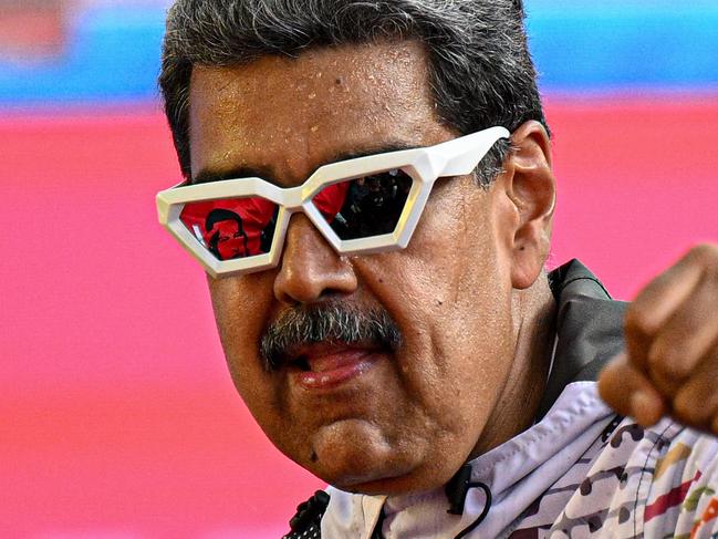 (FILES) Venezuelan President and presidential candidate Nicolas Maduro greets supporters during a campaign rally in Caracas on July 16, 2024. Venezuela's President Nicolas Maduro has been written off many times during a turbulent decade in power. But the former bus driver and anointed heir of Hugo Chavez has stubbornly clung to the wheel. (Photo by Federico PARRA / AFP)