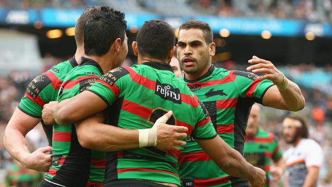 Bryson Goodwin and Greg Inglis of the Rabbitohs congratulate Alex Johnston as he celebrates scoring a try.