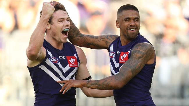 Lachie Neale and Bradley Hill celebrate a goal.