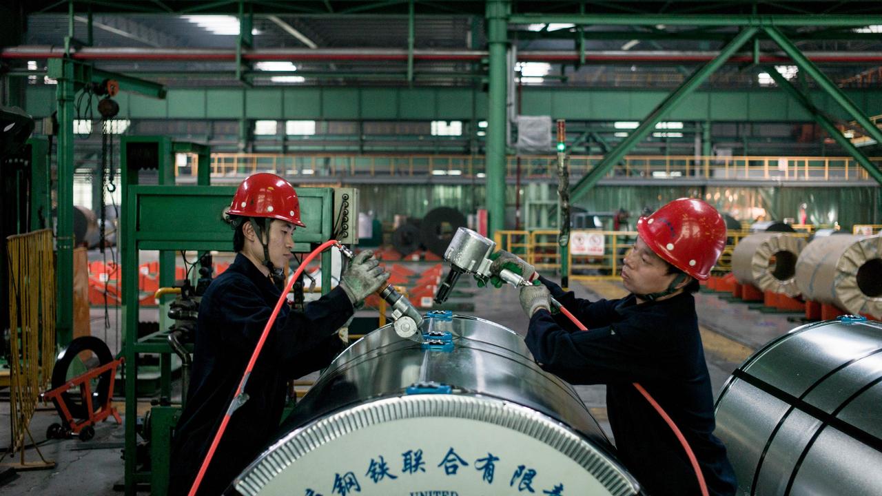 Chinese workers pack steel rolls in a steel factory in Tangshan, Hebei province. Picture: AFP/Fred Dufour