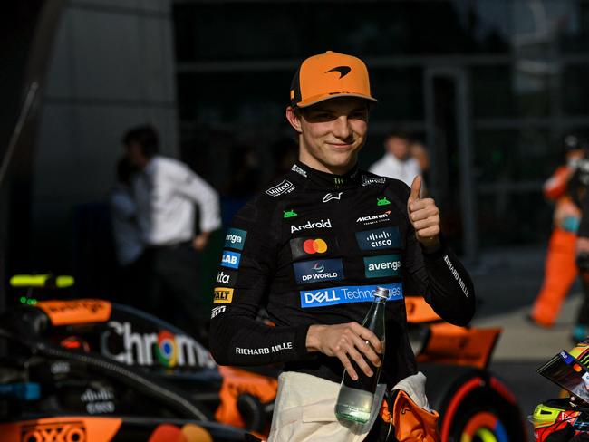 TOPSHOT - McLaren's Australian driver Oscar Piastri gives a thumbs as he celebrates taking pole position in the qualifying session of the Formula One Chinese Grand Prix at the Shanghai International Circuit in Shanghai on March 22, 2025. (Photo by GREG BAKER / AFP)