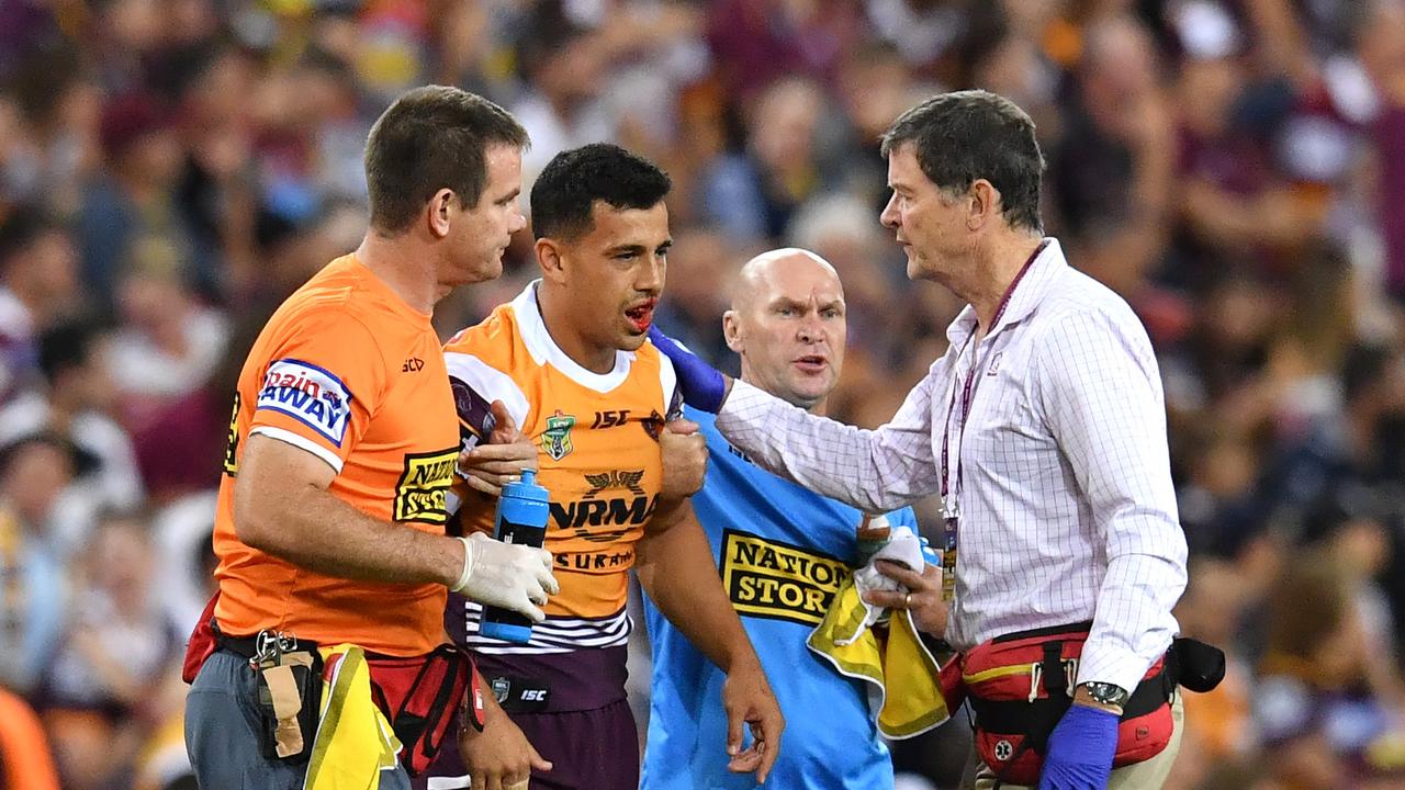 Jordan Kahu is helped by medical staff after being injured in Round 2.
