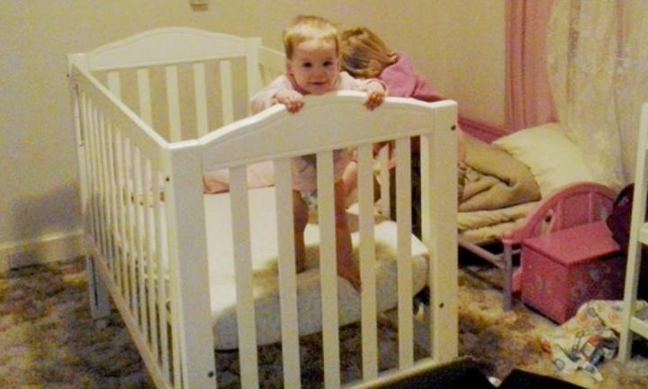 Crib with side that drops clearance down