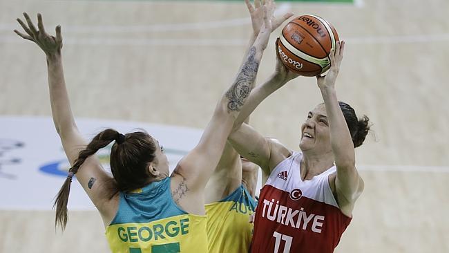 Turkey centre Nevriye Yilmaz (11) shoots over Australia forward Cayla George during the first half of a women's basketball game at the Youth Center at the 2016 Summer Olympics in Rio de Janeiro, Brazil, Sunday, Aug. 7, 2016. (AP Photo/Carlos Osorio)