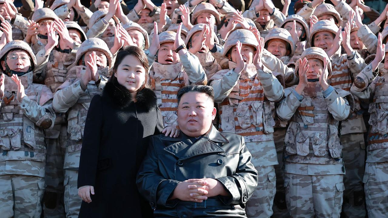 North Korea's leader Kim Jong-un (front) and his daughter posing with soldiers. Picture: KCNA VIA KNS/AFP