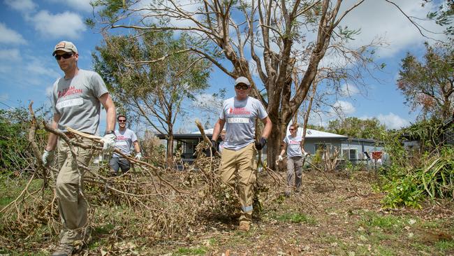 Team Rubicon Australia members remove branches from a property in Proserpine after Cyclone Debbie. Picture: Adil Jain.