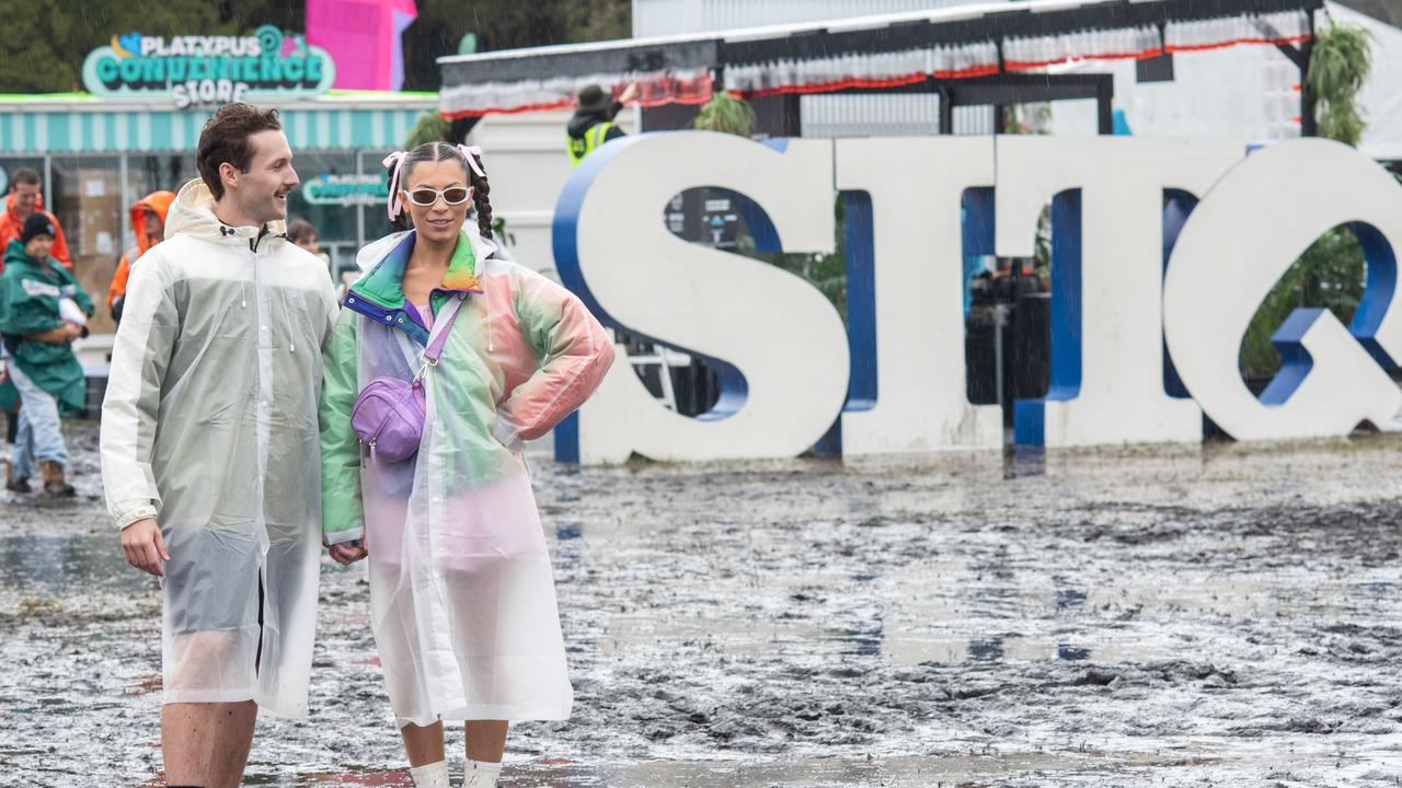 Jordan Belyea and Rachel Johnston are seen in the mud at Splendour in the Grass (Photo by Marc Grimwade/WireImage)