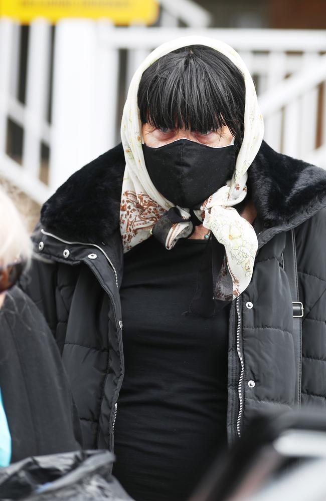 Arthurell is removed from her Yagoona unit by a community corrections officer. Picture: John Grainger