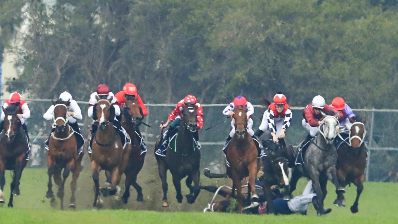 Hugh Bowman on Smart Image wins race 1 the Sky Racing Active Handicap as Andrew Adkins is seen falling.